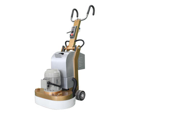 A concrete floor grinder with a silver body, gold color accents, and six grinding heads attached to the base.